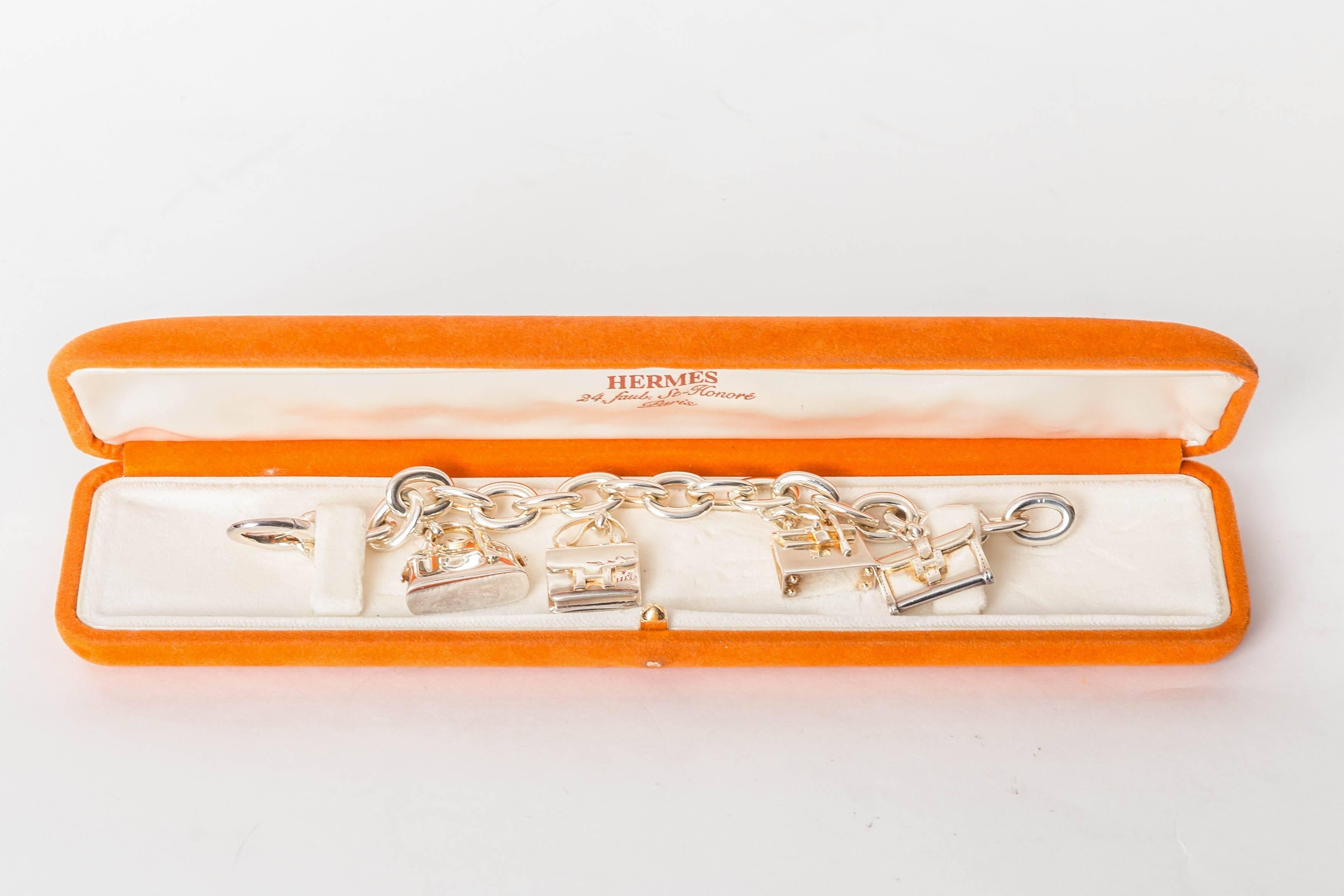 Rare Hermes Sterling Silver 4 Handbag Charm Bracelet with Gold Detail
Toggle Closure
Original Hermes Box is Included
Four Beautifully Crafted Hermes Handbag Charms Hang From This Beautiful Bracelet
This Sensational Bracelet Measures 7.5 Inches
