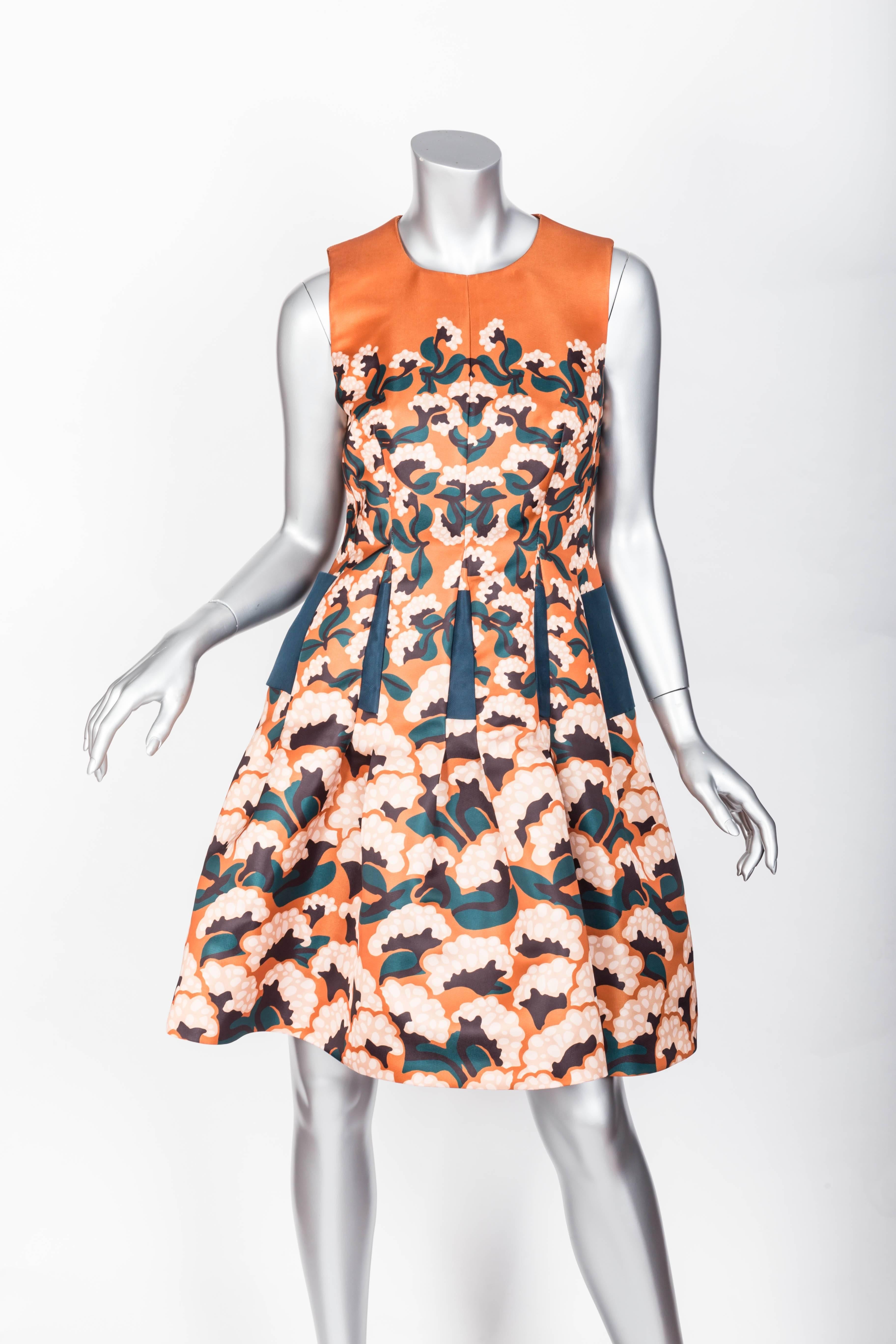 Gorgeous Thakoon Dress with floral print in shades of burnt orange, teal, cream and black.
Beautiful silhouette with very sculptural skirt and exposed back zip.
Condition is excellent.