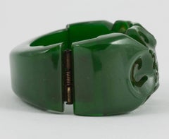 A carved green bakelite clamper bracelet, with stylised floral motif, USA, 1930s
