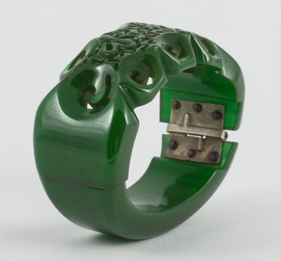 Women's A carved green bakelite clamper bracelet, with stylised floral motif, USA, 1930s For Sale