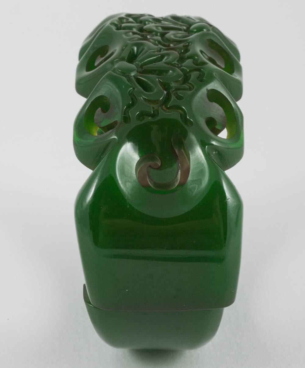 A carved green bakelite clamper bracelet, with stylised floral motif, USA, 1930s For Sale 1