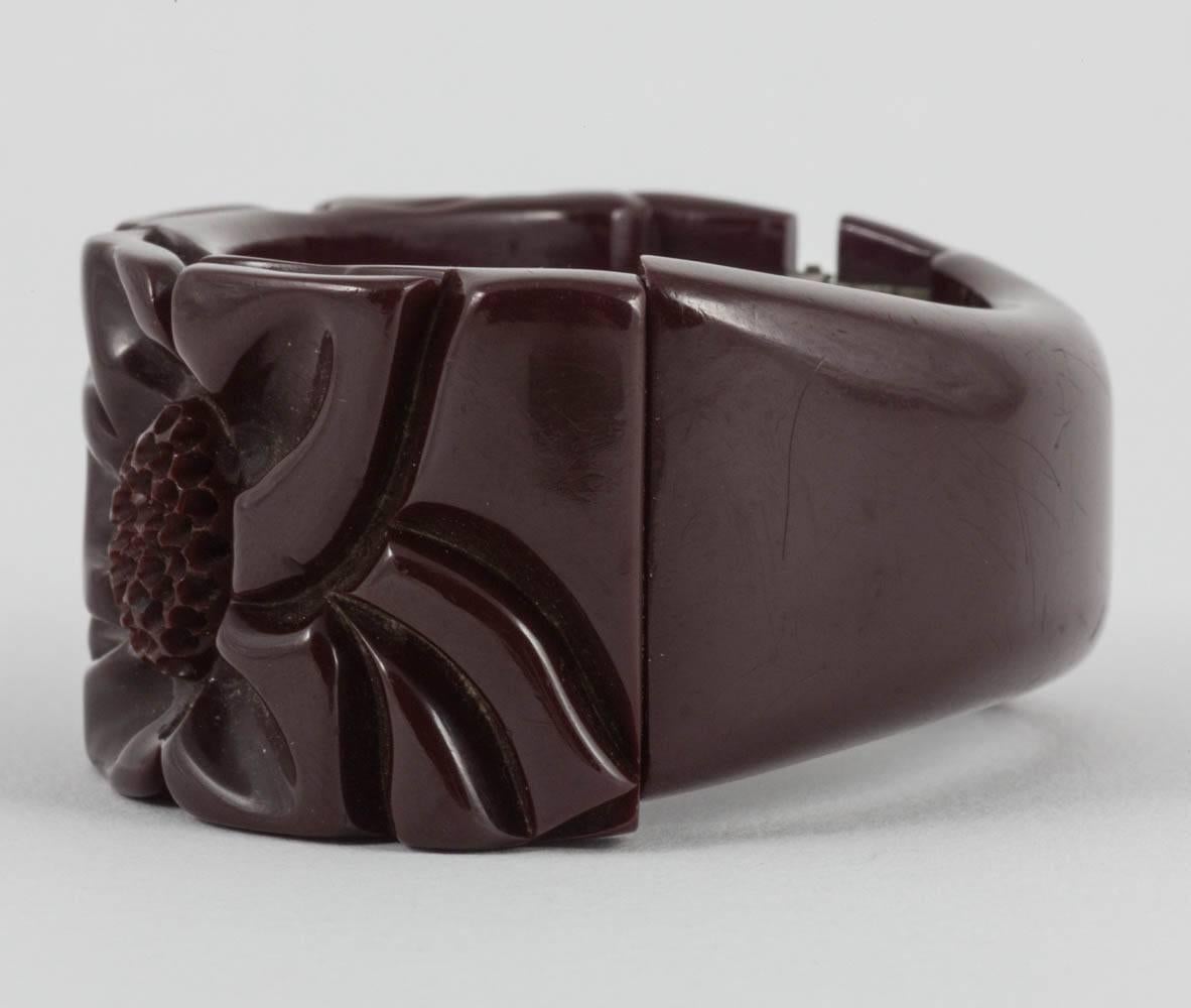 A carved maroon bakelite 'clamper' bangle, with floral motifs, USA, 1930s In Good Condition For Sale In Greyabbey, County Down