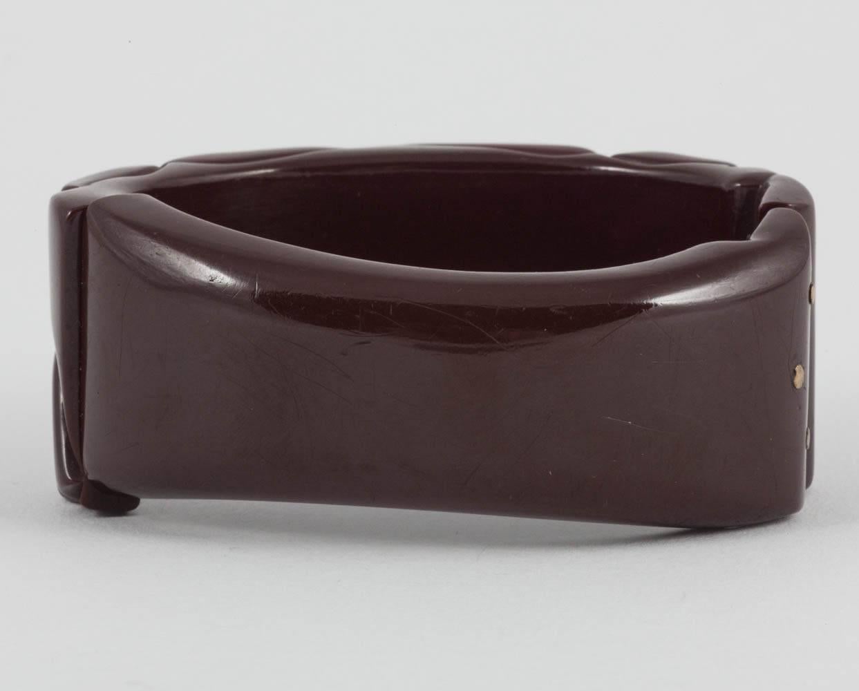 Women's A carved maroon bakelite 'clamper' bangle, with floral motifs, USA, 1930s For Sale