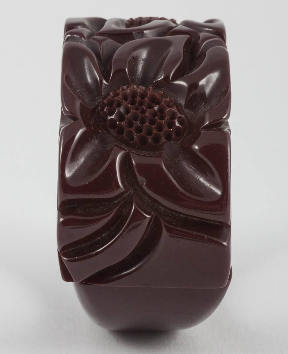 A carved maroon bakelite 'clamper' bangle, with floral motifs, USA, 1930s For Sale 2