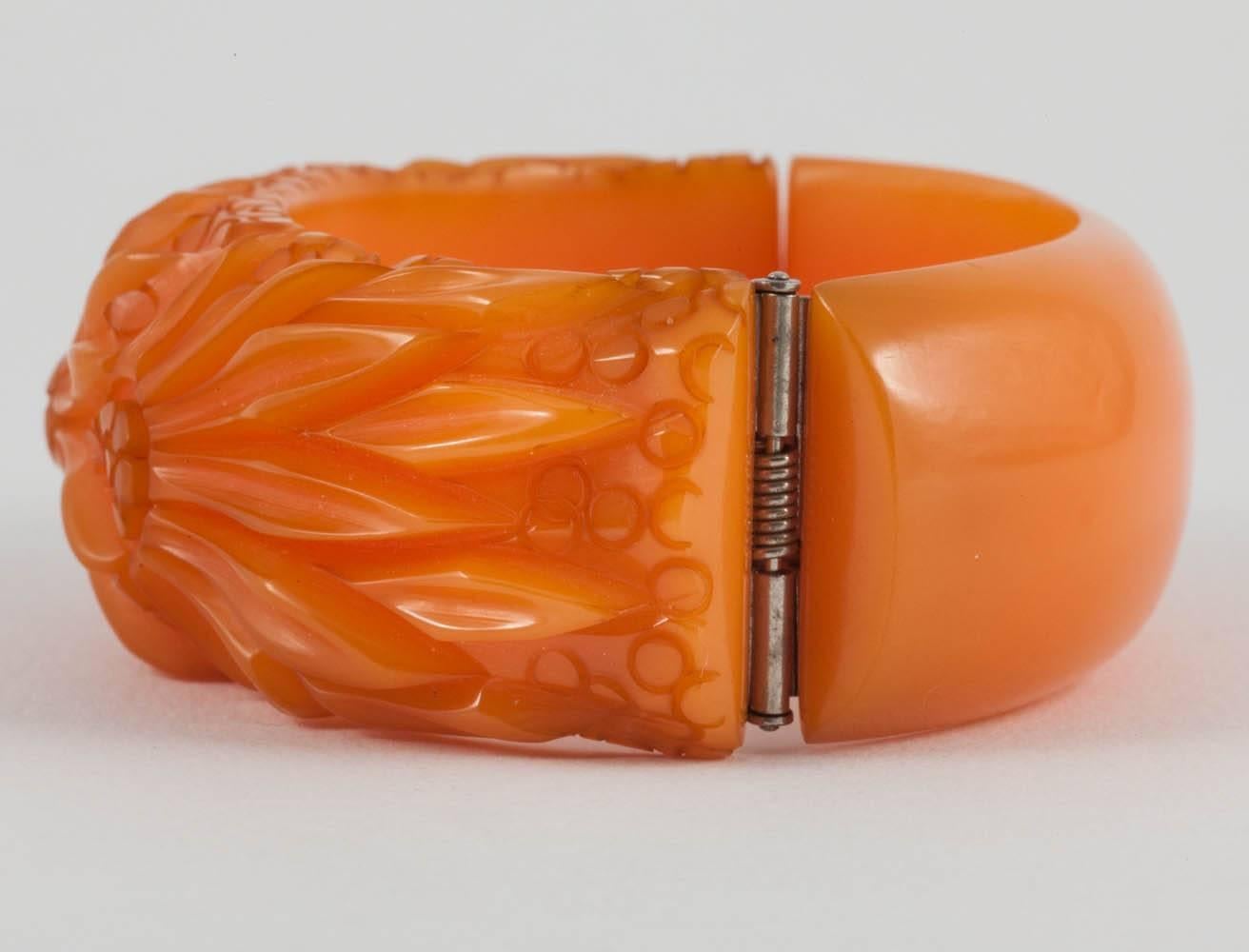A beautiful hand carved Bakelite bracelet, in a soft amber colourway, from the 1930s
The hinged mechanism works perfectly and securely.
This is one of a group of five similar Bakelite bangles being sold (all pictures below), three were listed last