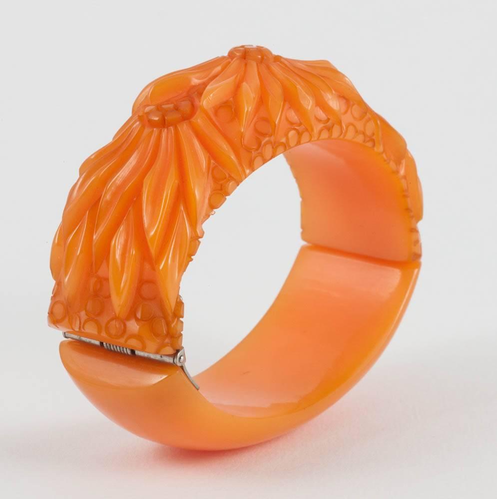 A carved amber Bakelite 'clamper' bracelet, with floral motif,  USA, 1930s In Good Condition For Sale In Greyabbey, County Down