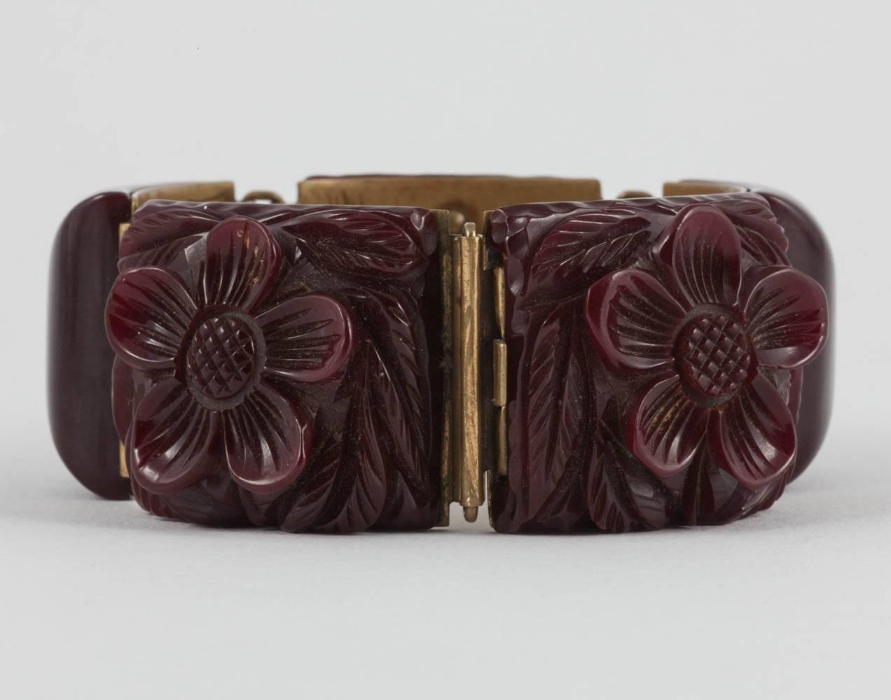 A very strong carved maroon Bakelite bracelet, with a stylised flower design, on every other panel, a gently polished and curved piece of Bakelite on the other panels. Set in brass, this is a beautiful and very wearable bracelet.