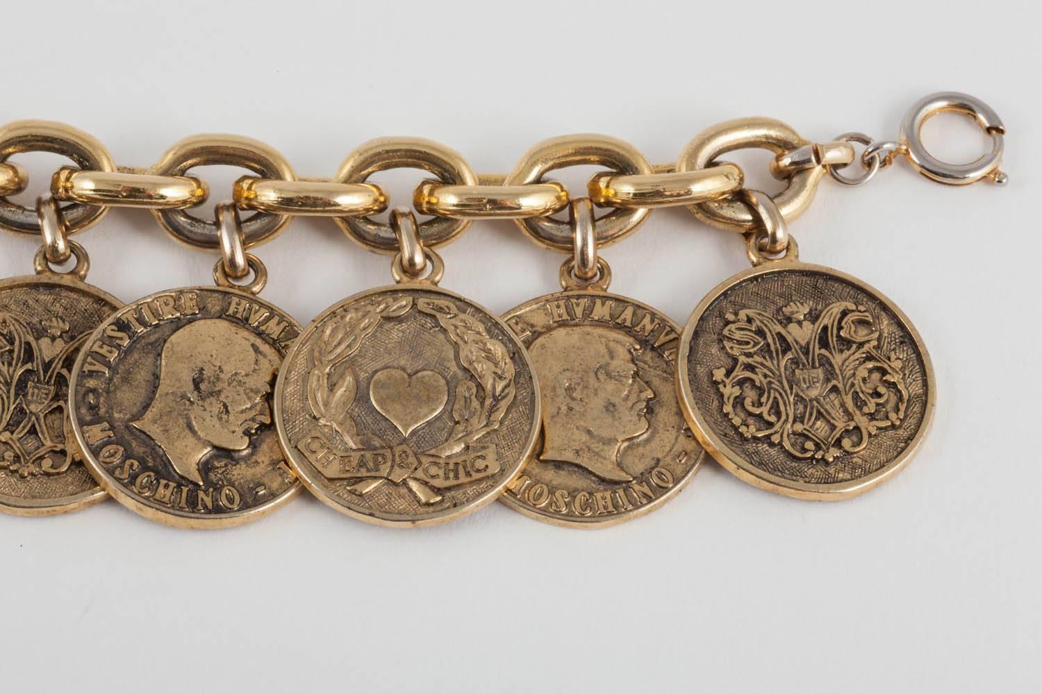 Franco Moschino introduced his Cheap and Chic range in 1988 and this was one of the early pieces for that line. Hung from a shiny thick gilt chain, there are wonderfully chunky and bold antiqued coins with faces, cowboy hats and faux coats of arms