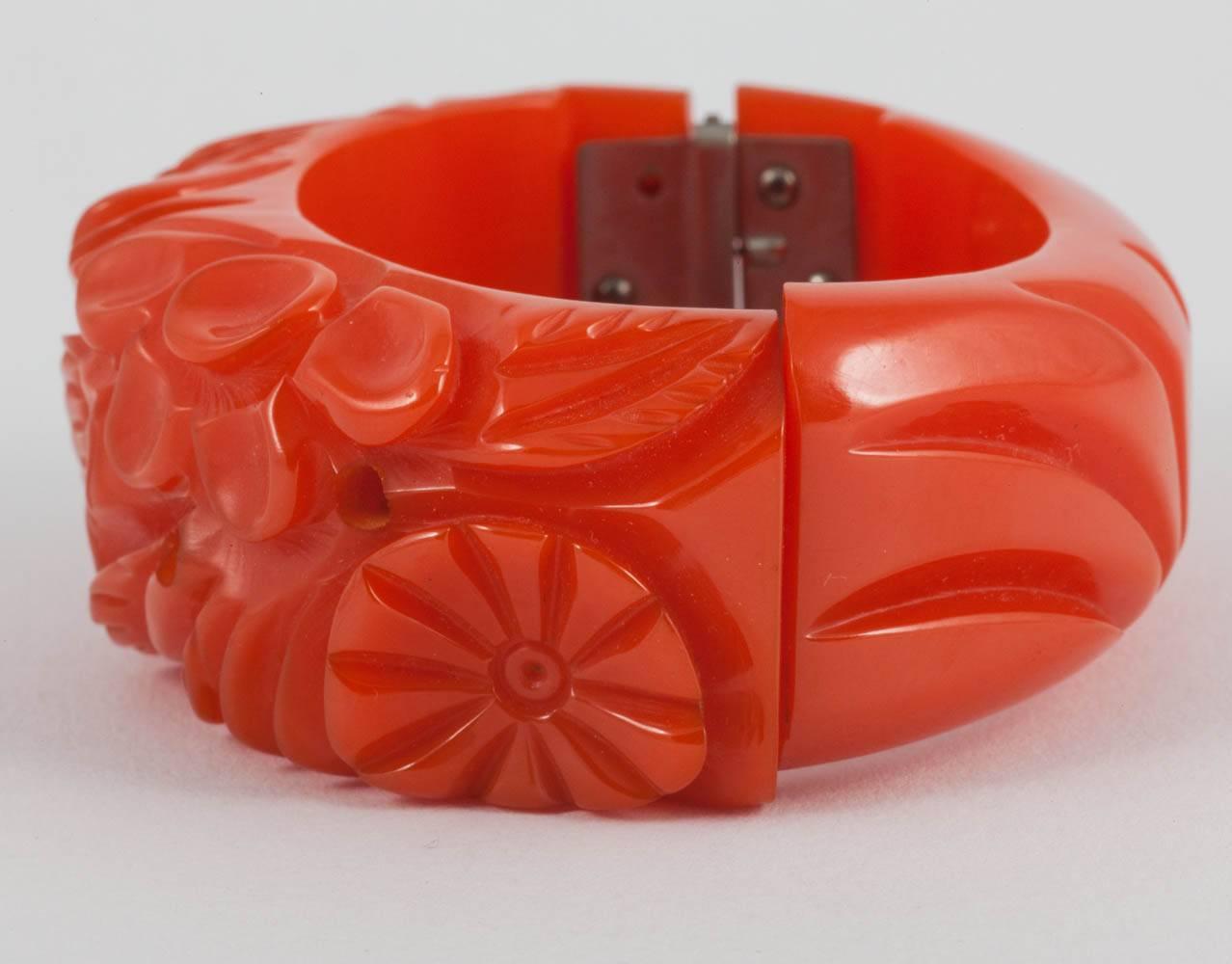 A beautiful hand carved bakelite bracelet, in a vivid,strong and unusual orange colourway, from the 1930s.
The hinged mechanism works perfectly and securely.
This is one of a group of five similar bakelite bangles being sold (all pictures below),