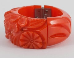 Carved orange bakelite 'clamper' bangle, USA, 1930s.