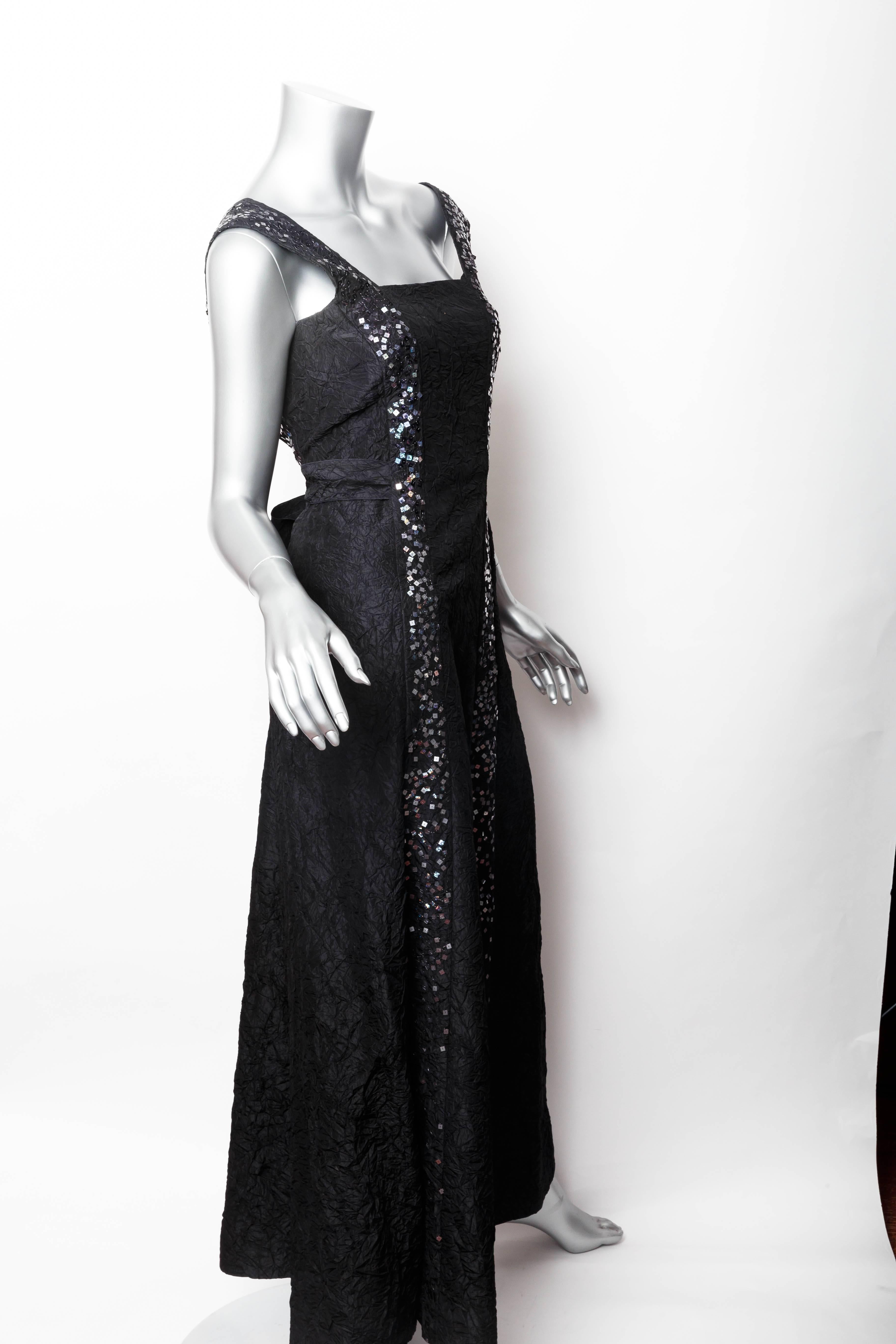 Stunning Chanel gown in black silk with sequin embellishment.
Back zip with long black sash 