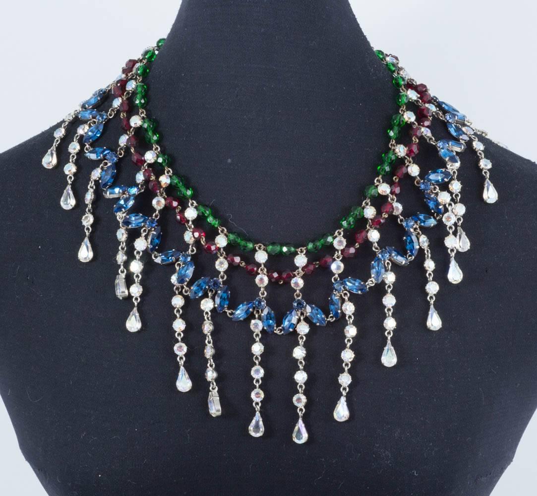 A very flamboyant large necklace/collar, in sapphire and iridescent pastes, and emerald and ruby glass beads, all set in a white metal, dripping with glamour and dynamism!
Egyptian in style, as were many pieces of this kind created around this time,