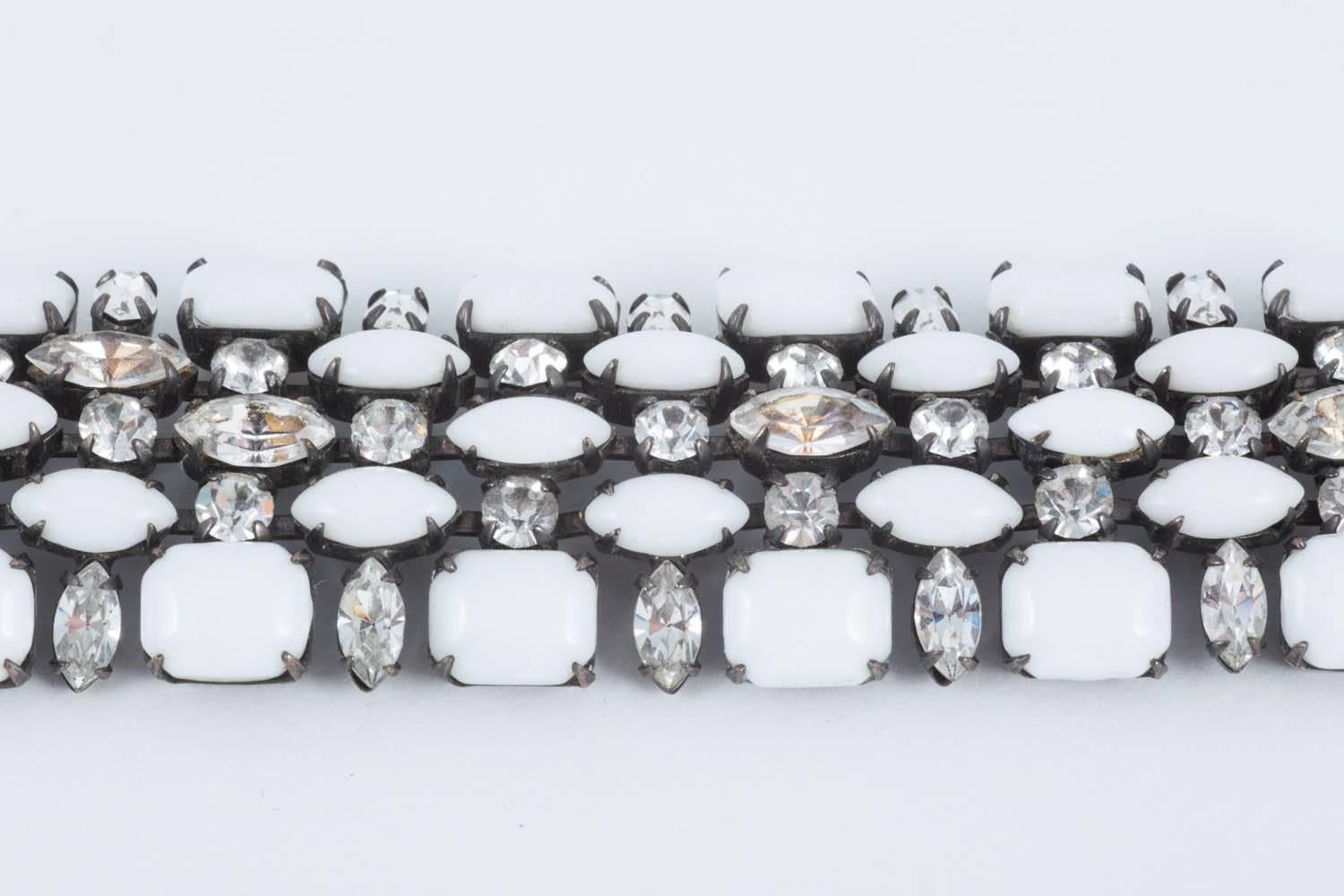 Ultra chic hand set pure white milk glass stones in rectangle and marquise cut, with clear round and marquise cut paste. All hand prong set on a japanned metal backing.
Beautifully made with a sinuous fluidity that makes this bracelet wonderful to