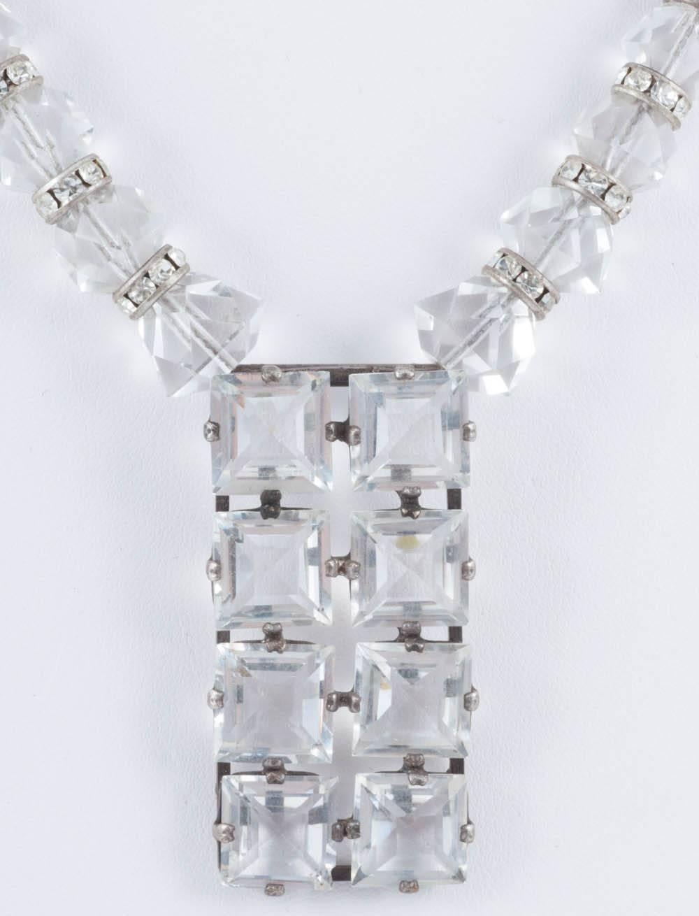 This is a lovely 1930s necklace featuring paste roundels interspersing cut crystal beads and a very geometric cut glass pendant. This necklace is a good length and a strong look whilst the limited palette makes it wearable year round, day to