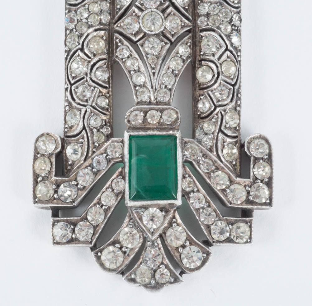 This pendant is of the highest quality,a large emerald square cut paste and clear pastes, set in a high Art Deco silver design, made in France in the late 1920s, the height of the Jazz Age. It comes without a chain, but would be easy to mount on a
