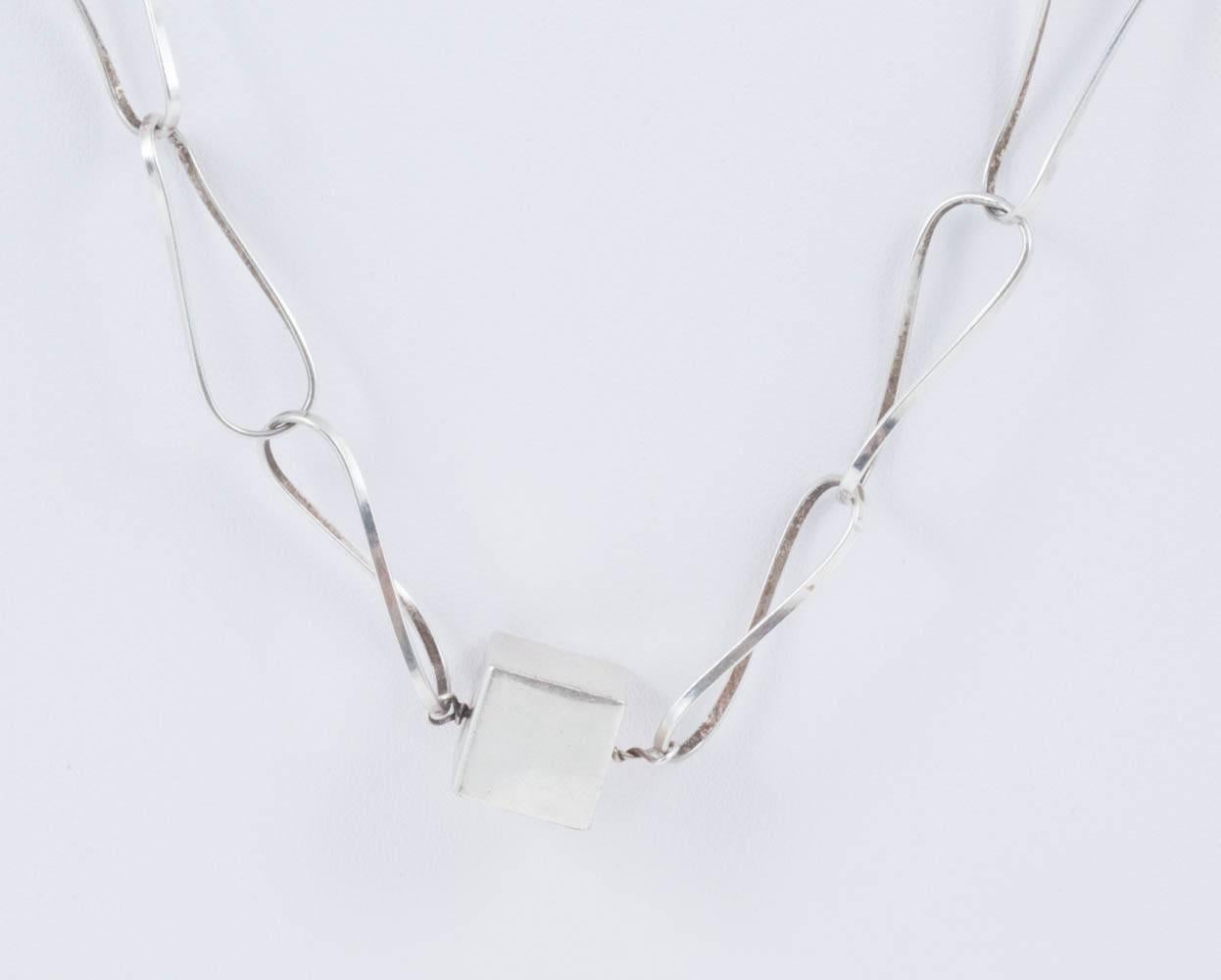 This is a lovely light necklace, with wonderful large twisted hand made links and hollow silver cubes. A great every day piece which manages to be both big enough to make an impact,and delicate enough to be in the modern taste. This is not signed