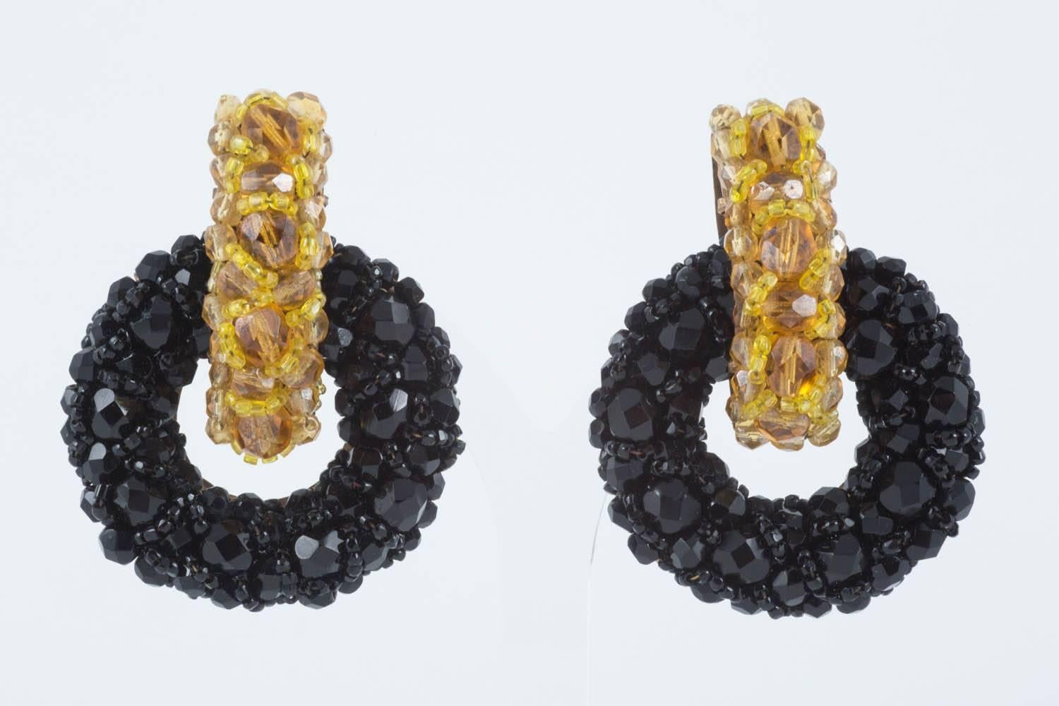 These magnificent large earrings, from Coppola e Toppo, made from pave- embroidered half-crystal faceted beads in jet black and topaz, are constructed of one  piece of hand cut metal, the beadwork encrusted on top. Chic and a great colour