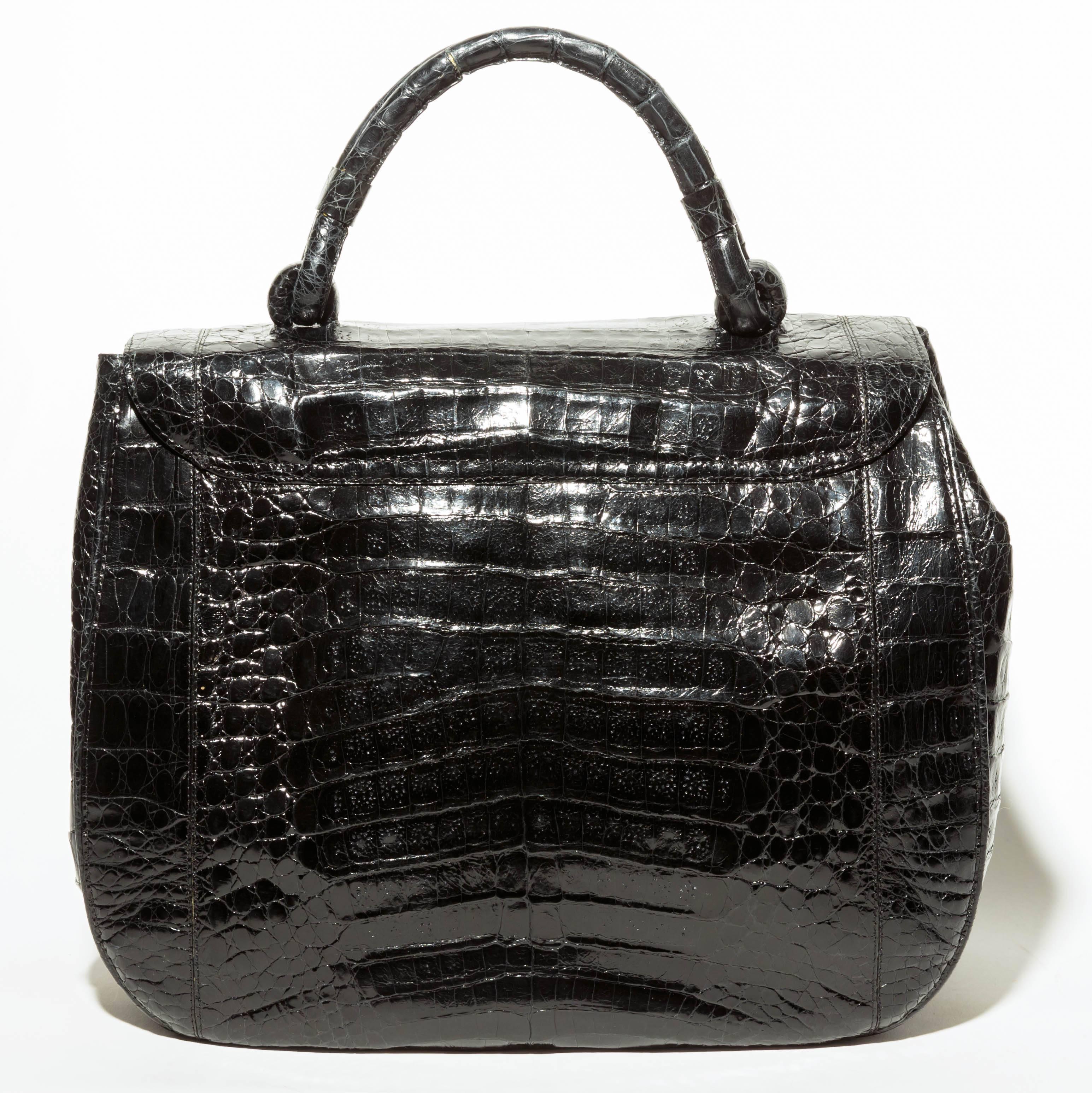 Beautiful Nancy Gonzalez Black Crocodile Top Handle Handbag
Condition is excellent.
Top handle measures 11 inches with a drop of 4 inches.