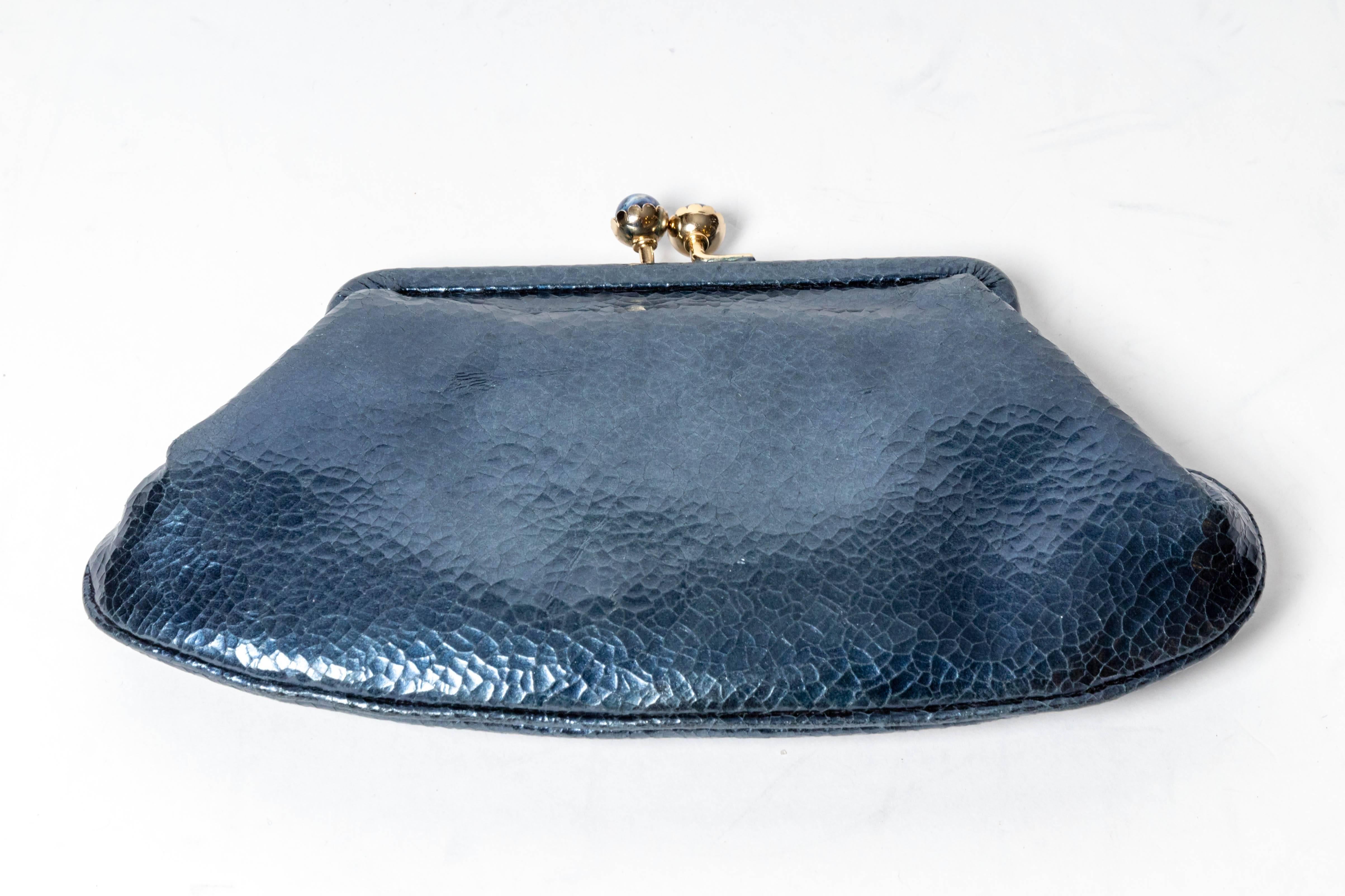 Sweet Anya Hindmarch suede lined clutch with jeweled clasp.
Condition is excellent.
5 inches from top of clasp to bottom. 
9 inches at widest point. 5 inches across top of clutch. 