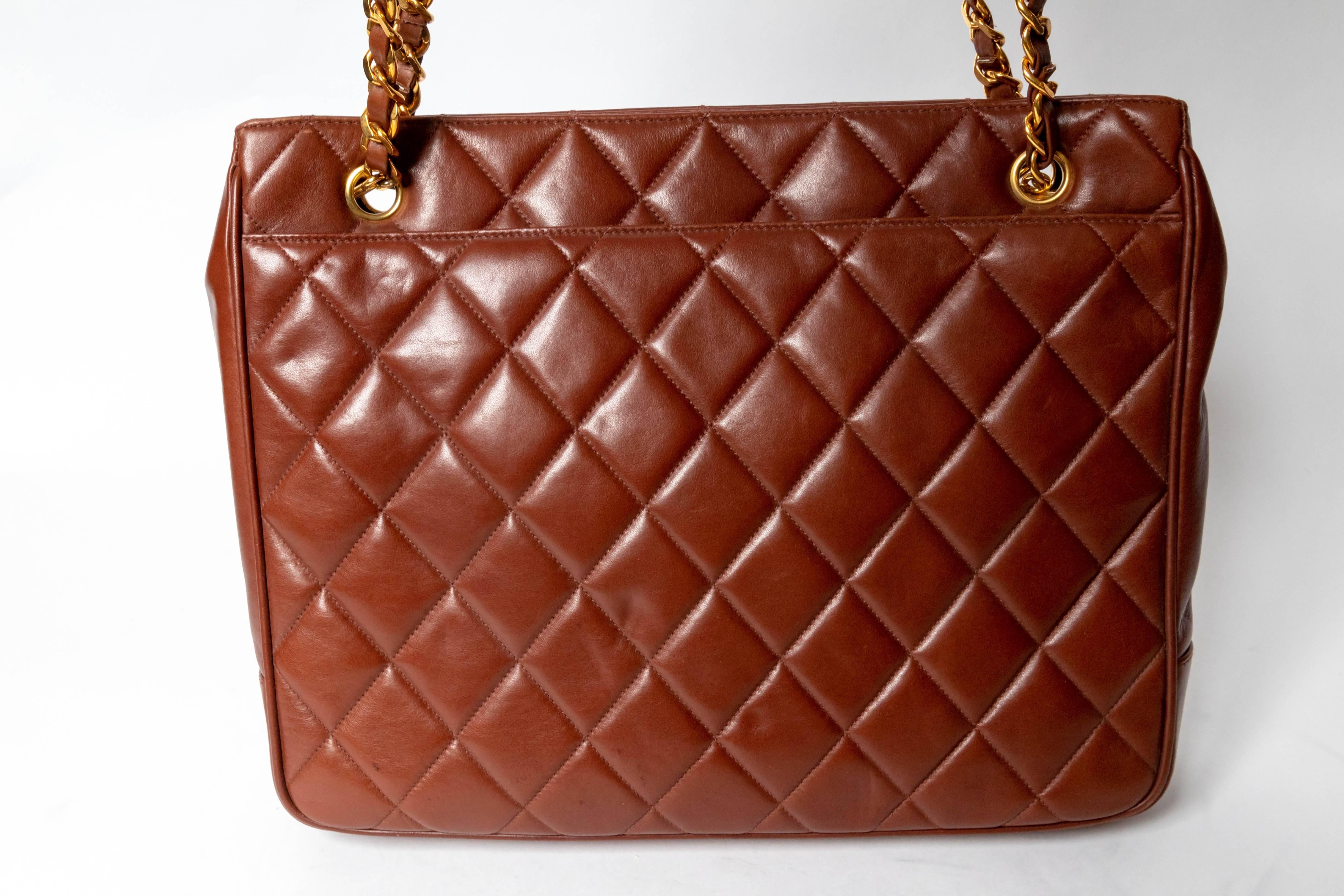 This Incredibly Chic Brown Lambskin Chanel Shoulder Bag has its original tickets still attached. 
Made between 1994 - 1996, the bag is in excellent condition.
Adorned with Chanel's iconic bead ball, this bag has exterior flap pockets and a snap