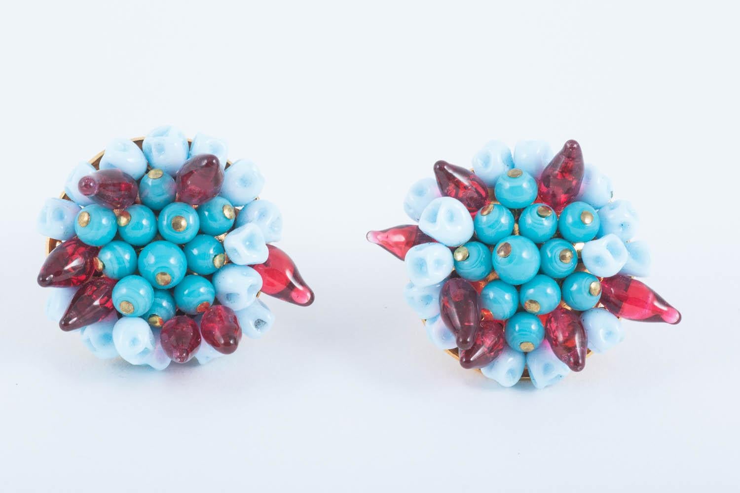 Beautiful large cluster earrings, hand made by artisans if Paris by Histoire de Verre.
Compromising of two tones of turquoise glass beads, the lighter 'pinched' at the tip , to form 'blossom' like beads, the darker beads are round. Both earrings are
