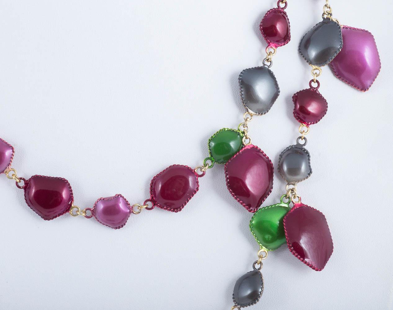 A hand made double strand necklace from the WW Collection -  various sized and shaped soft raspberry red, steel grey and grass green 'charms', hand enamelled, free moving, hang from and line  the two rows, a smart and easy to wear item.

From the