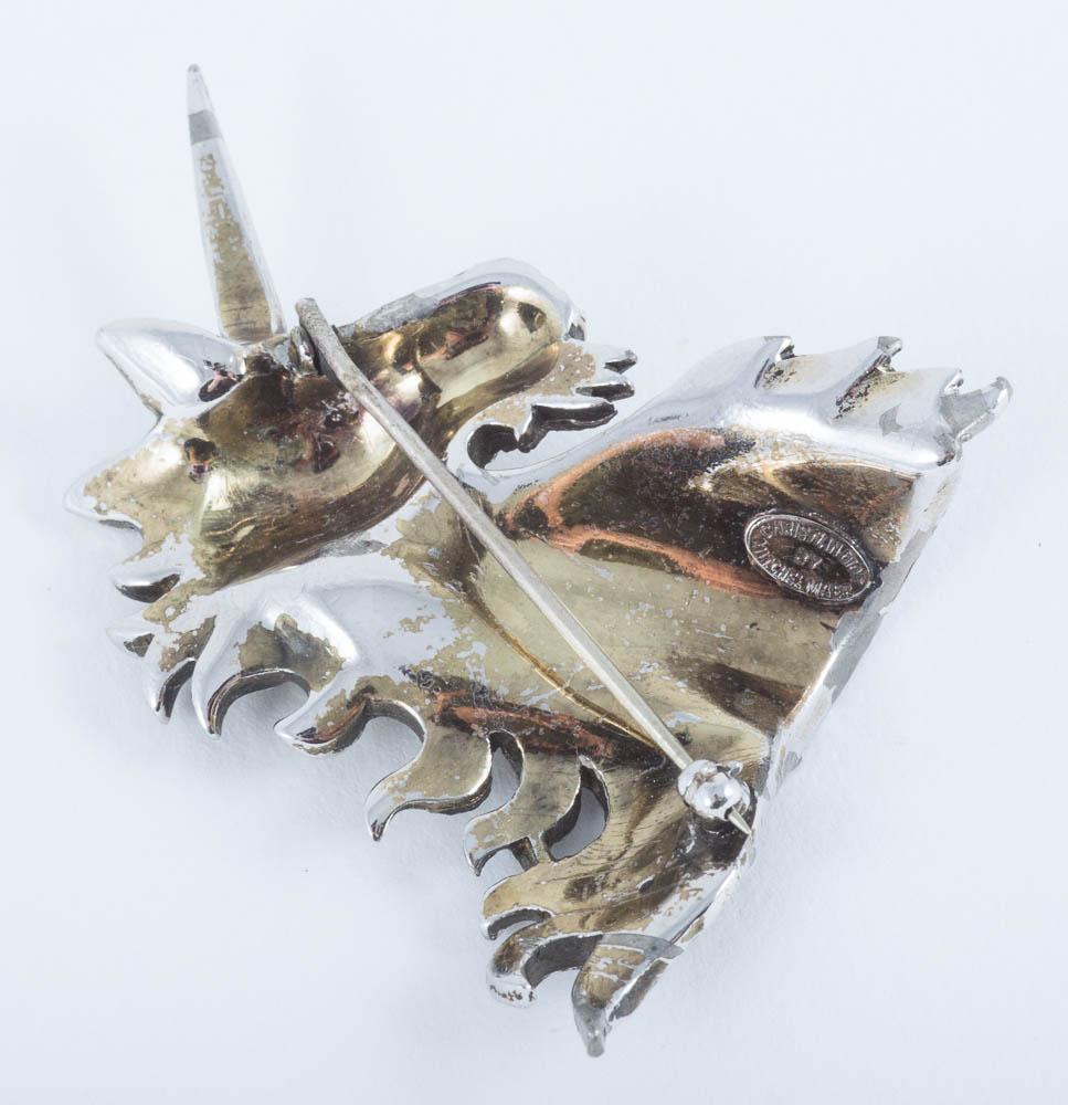 A pair of paste and gilt metal 'unicorn' brooches, Christian Dior, c1954. 2