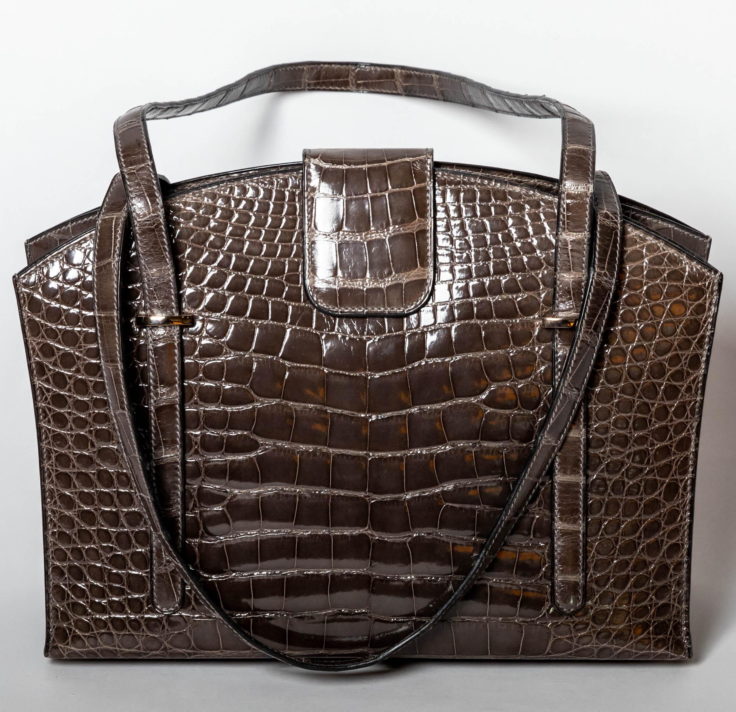 Rarely seen on the secondary market, an extraordinary Hermes alligator Lyn handbag in graphite alligator.
Only produced in the year 2000, this bag is incredibly hard to find.
One interior zip pocket as well as two flap pockets.
Condition is