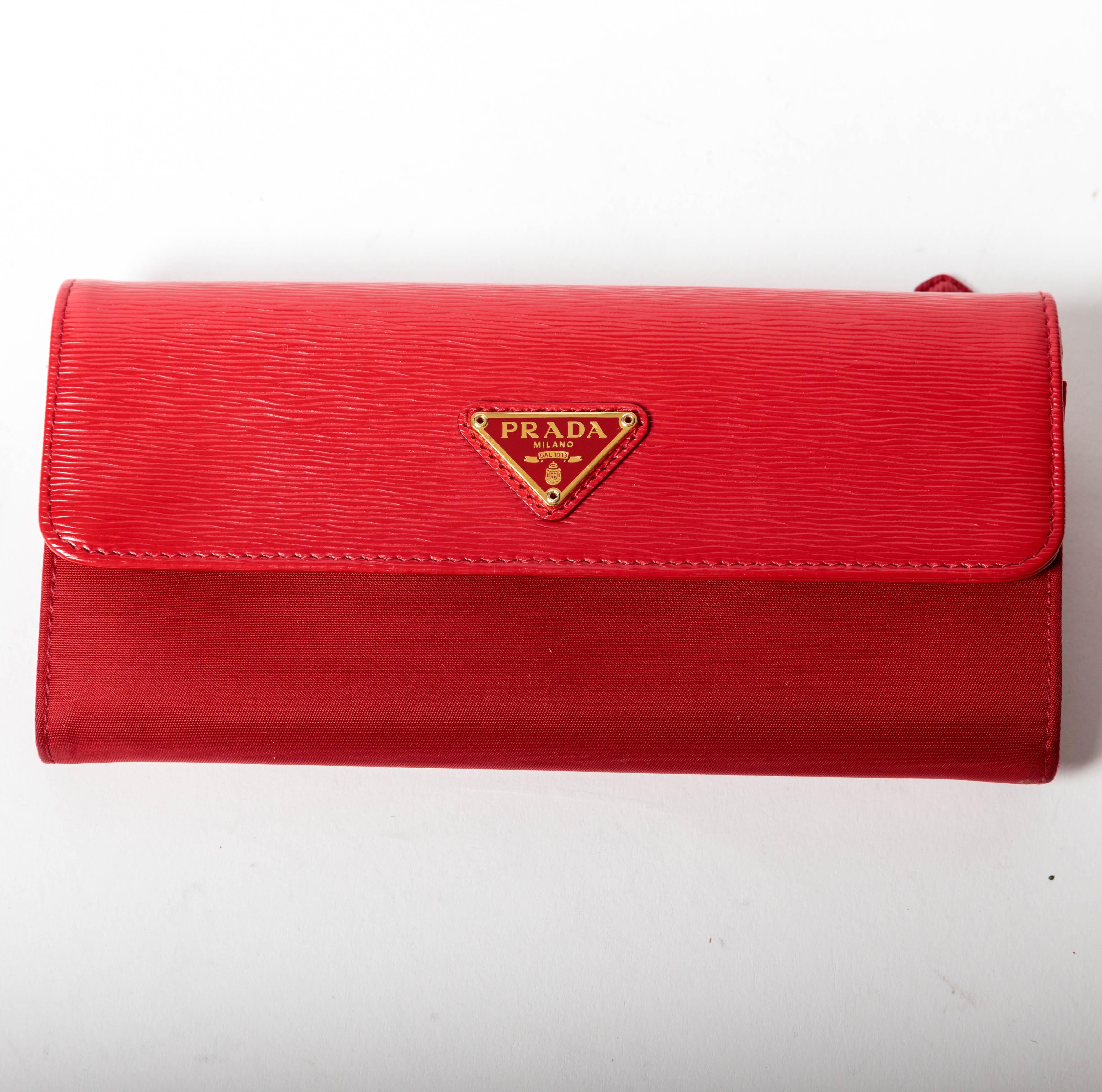 Incredibly chic Prada long wallet with snap on credit card case.
With slots for credit cards, several deep pockets for bills and a center zip compartment for coins and an outside zip pocket, this wallet is simply perfect.
Condition is very good with