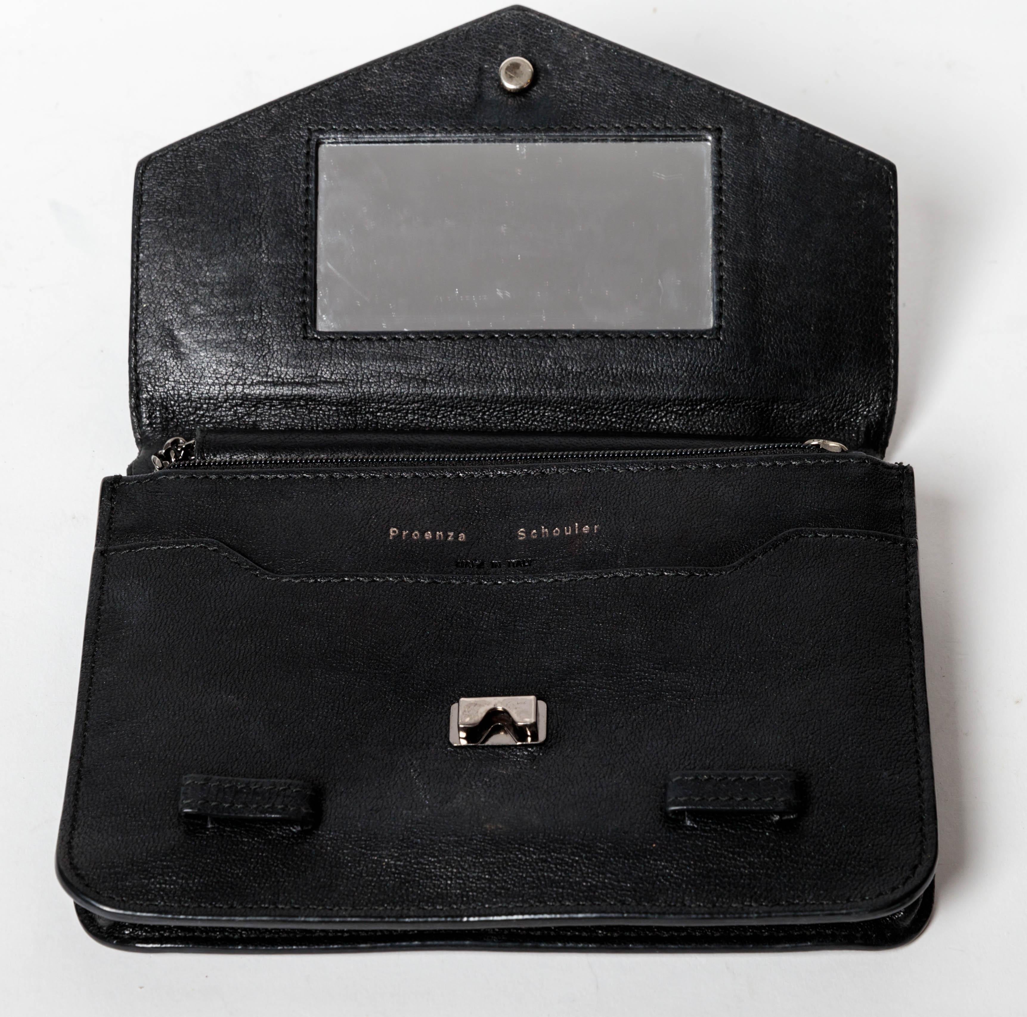 Black leather Proenza Schouler Wallet on a Chain.
Versatile and large enough to carry a phone, cards and some small essentials.
Includes interior zip pocket, slots for cards and a separate front flap pocket.
Great bag at a great price.
Excellent
