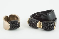 Black carved galalith, gilded metal clamper bangle and belt, French, 1920s/30s.