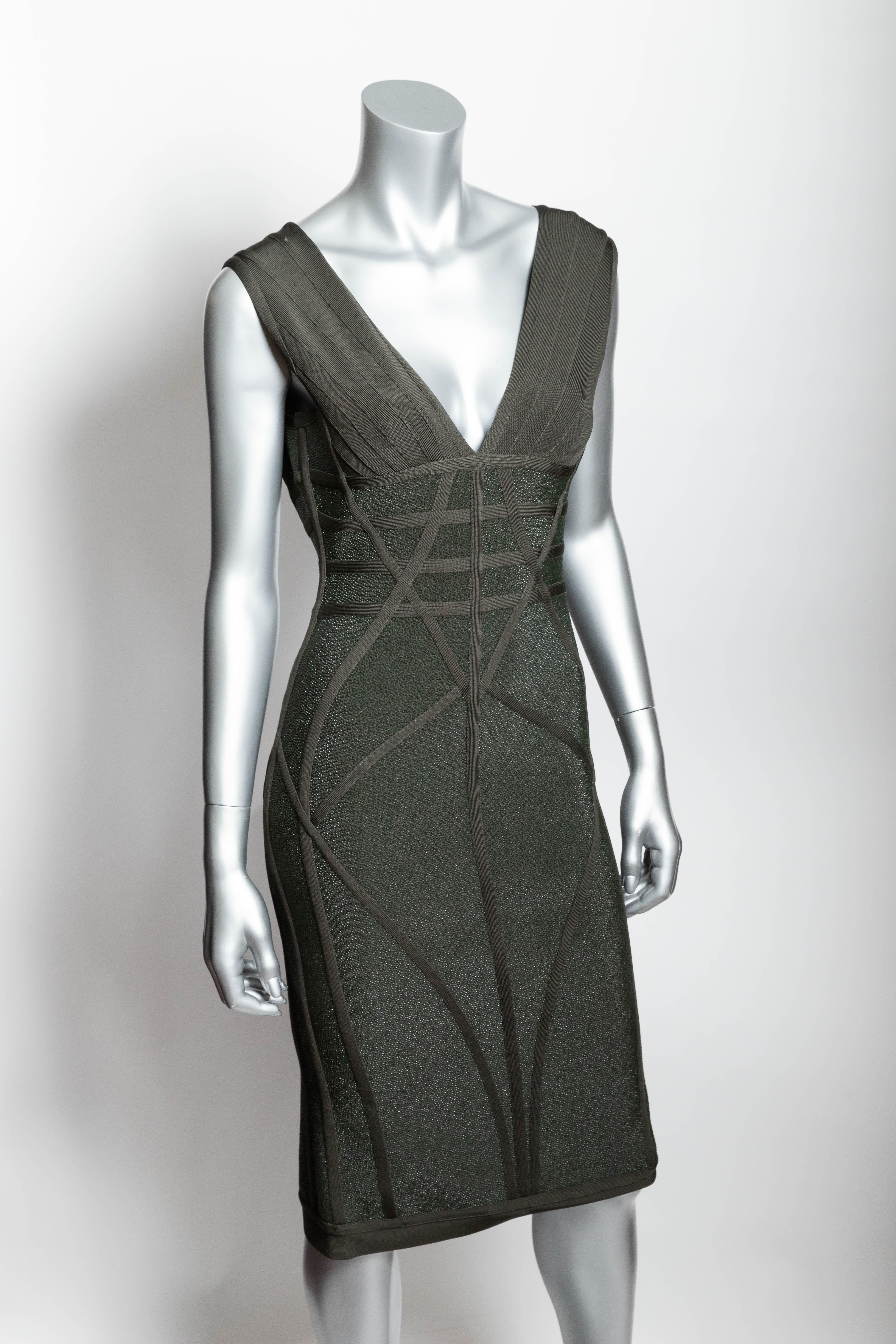 Very unusual and incredibly chic Herve Leger dress in a dark green shagreen like fabric.
This is the most forgiving Herve Leger dress that we have ever sold.
Back zipper  / zipper can zip up from the hem as well as zip down from the