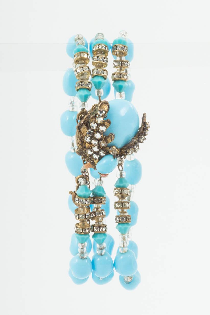 A very attractive and charming three strand bracelet from Miriam Haskell from the late 1950s, the cabuchon clasp all set with paste rose montes and the three rows of a soft turquoise coloured glass, highlighted with paste rondelles and clear beads.