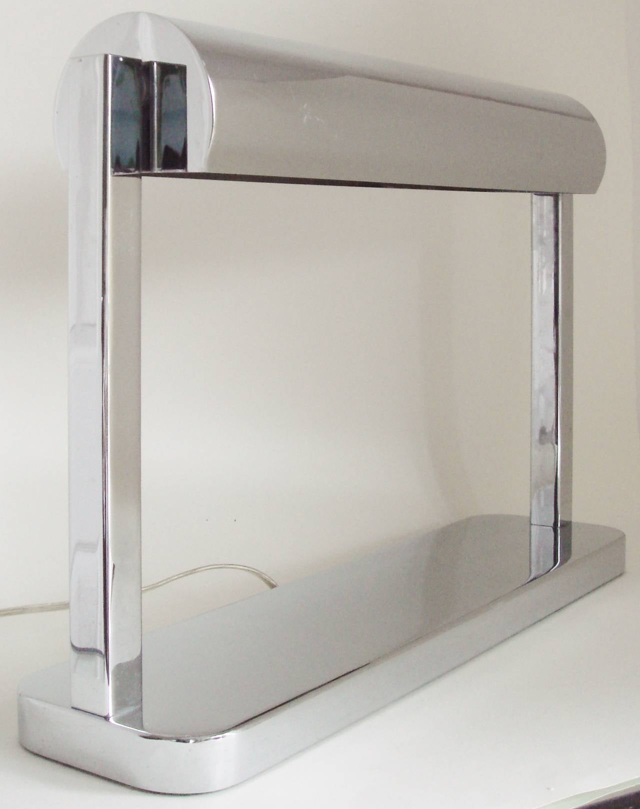 This very simply designed, large architectural and extremely striking American Art Deco Revival chrome adjustable banker's desk lamp is in wonderful condition. The tubular shade can be adjusted through almost 360 degrees and houses the two original