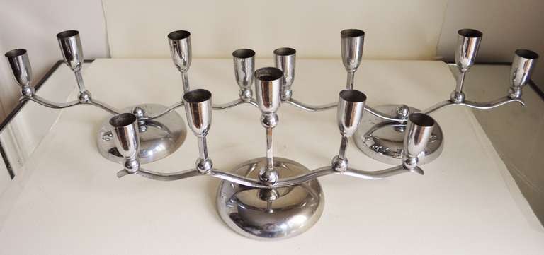 This set of German chrome plated candle holders consists of a pair that each feature four bobeches that flank one that has five. These were featured in photographs of the period running down the centre of a long dining table.
