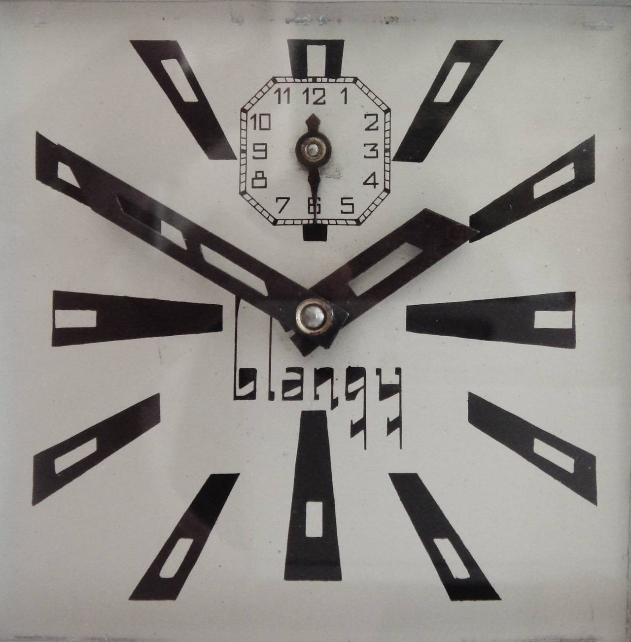 This is one fine looking ultra Art Deco styled French alarm clock from its radical flat chrome fretted front panel to the typographical design triumph of its numerals and hands. Even the wordmark of the manufacturer, Blangy, is extreme in its style