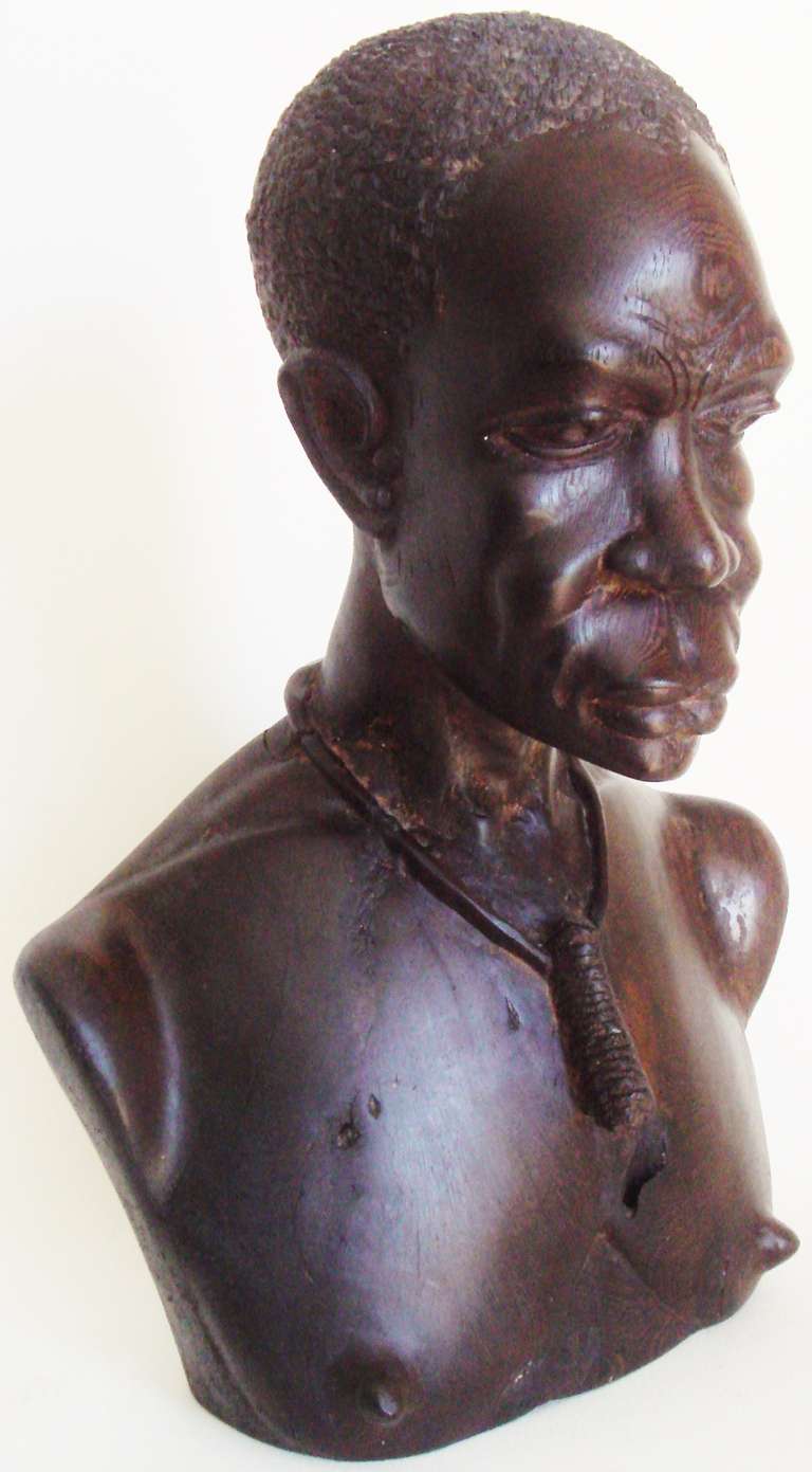 This hand carved Macassar Ebony bust of an African warrior is in the style of French sculptor Roger Favin and dates from the mid 30's. Favin's celebrated  African portrait sculptures were exhibited at both the 1929 Salon de la Societe Nationale and