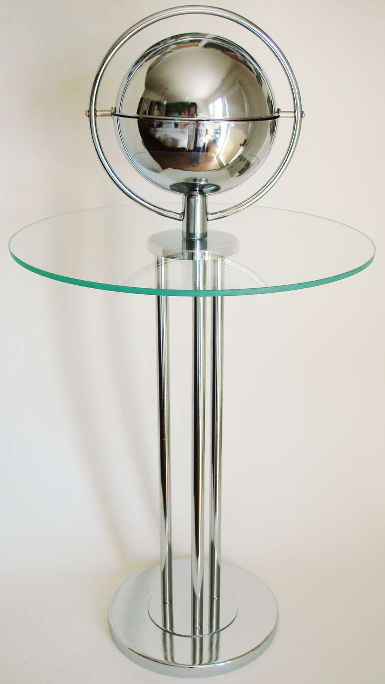 The design of this exquisitely executed and restored American Art Deco chrome and glass smoking stand/wine table was patented in 1935 by Wolfgang Hoffmann (Des. 94,308) and the patent assigned to The Howell Company of Geneva, Illinois. Above the