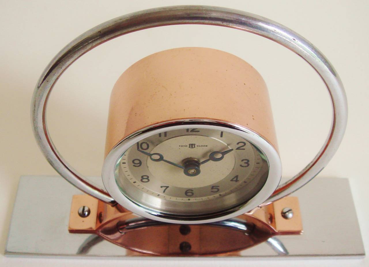 This rare distinctively designed Japanese Art Deco mechanical alarm clock is by Toyo. It is a triumph of geometric design and features the skilful contrasting of the copper and chrome finishes. It is in excellent condition and working well.