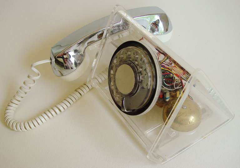 This triangular body of this scarce rotary telephone is constructed in totally transparent clear plastic and thus reveals its brightly coloured inside electrical workings. It was produced in the early seventies, named the La Belle Clear (#2250) and