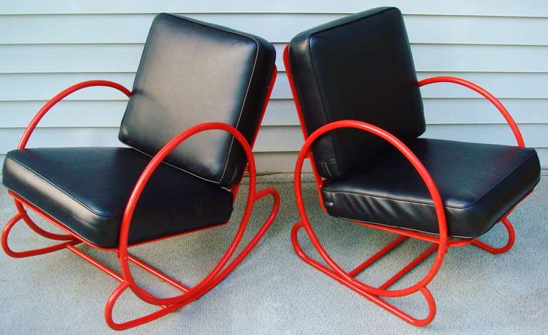 This striking two-piece set of American Art Deco red enameled tubular steel chairs with black vinyl loose cushions consists of a rocking chair and matching lounge chair. These were restored by the previous owner two years ago and remain in very good