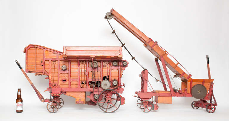 This extraordinary fully functioning, handcrafted salesman's sample/ museum  miniature of a late nineteenth century threshing machine and loader is believed to be one of two made and the only surviving example. It was used by salesmen in Europe to