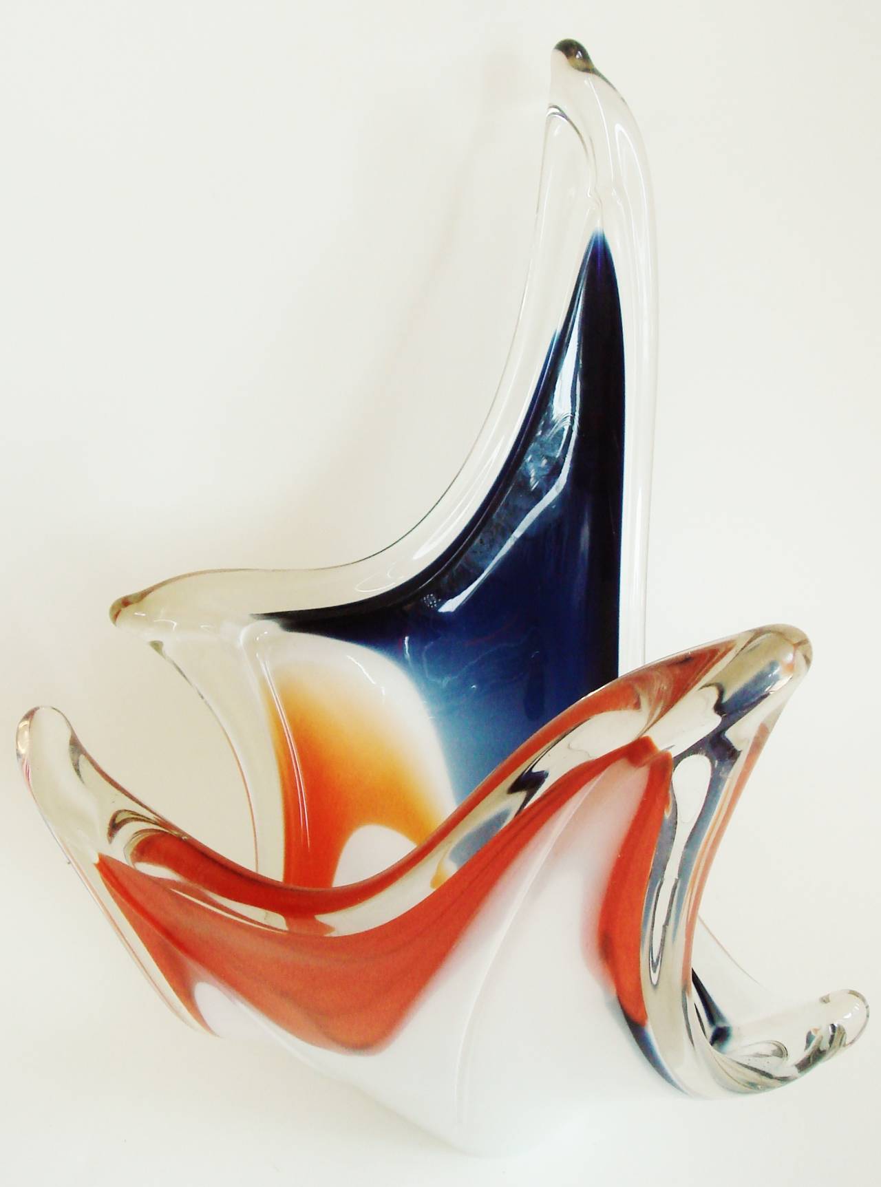 This wonderful Swedish Mid-Century Modern vide-poche/vase is an eccentric riot of blue, orange, white and clear glass in a free-form shape that is somewhat reminiscent of a butterfly in flight. It is unsigned but very much in the style of a