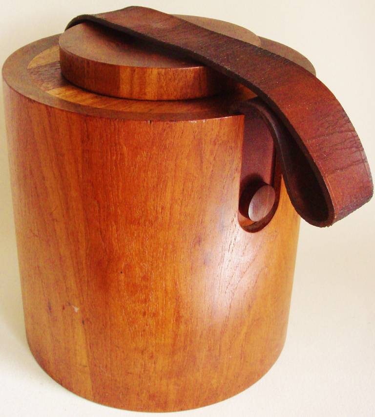 The design of this drum shaped staved teak ice bucket has been attributed to Jens Harald Quistgaard for Richard Nissen and indeed it is signed with the impressed Nissen manufactures mark to the underside of the base. It has its original thick