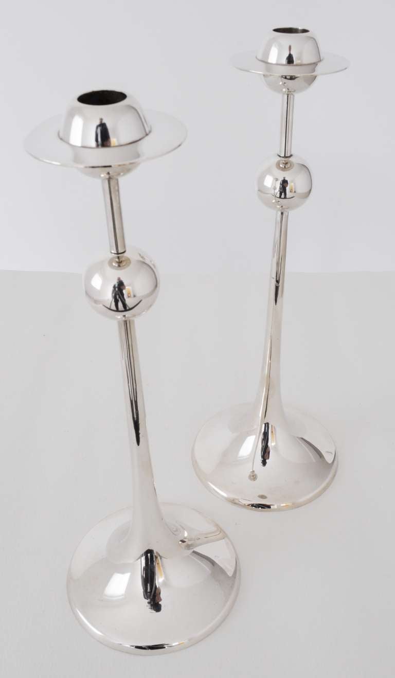 These very elegant tall 1960s modern Swedish Saturnus silver plated candlesticks feature a sphere half way up the shaft and then a wonderful Saturn shaped bobeche at the top. They are examples of the tallest model of the three sizes of these