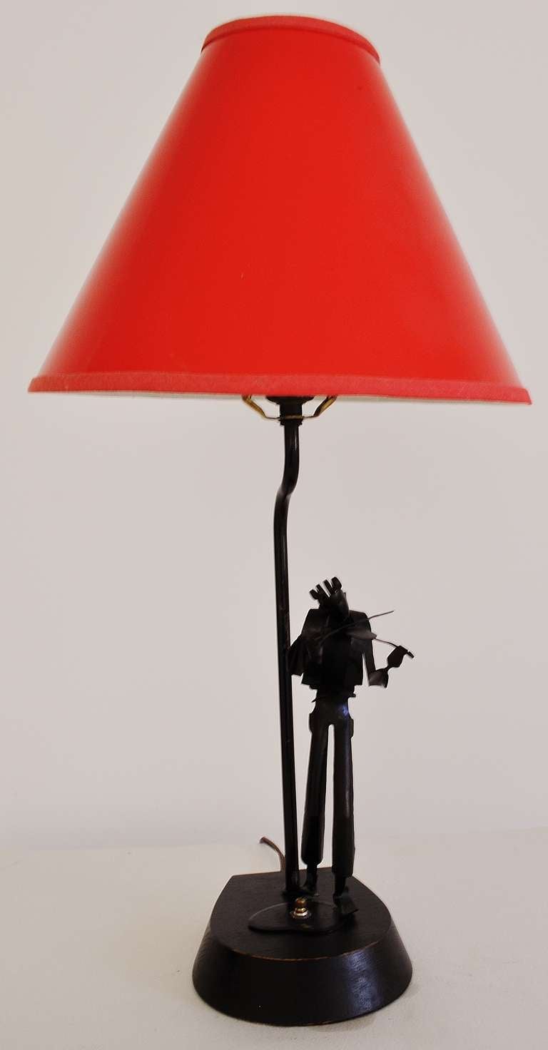 This wonderful pair of table lamps each features a figure of a musician ingeniously and beautifully crafted from what would appear to be a single sheet of folded metal and made in post-war West Berlin. We have sold certain examples of these