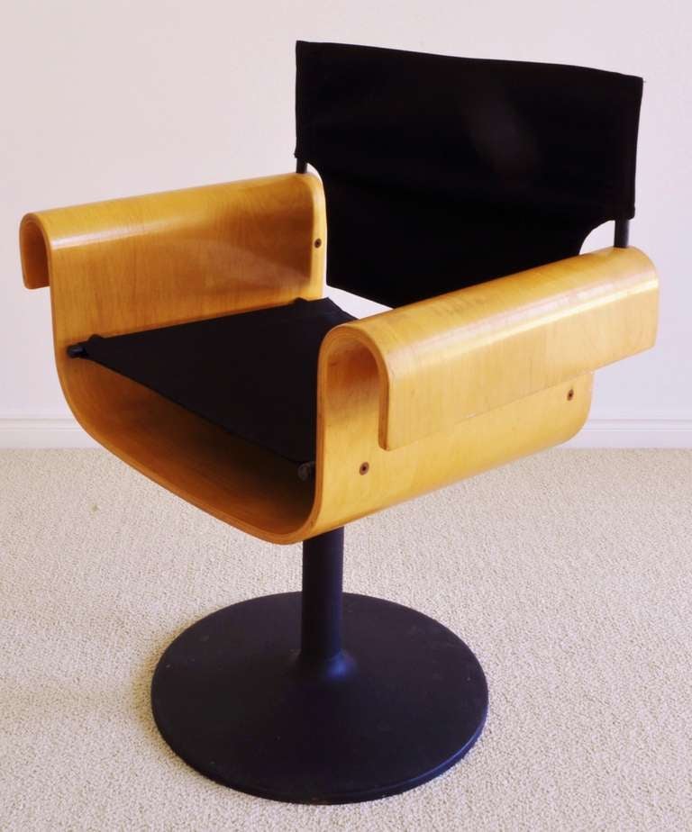 This beautiful, architecturally formed, Mid-Century Modern set of four swivel base chairs were manufactured by the small Canadian company PlyDesign of Orono, Ontario. They are constructed from natural varnished bent plywood shells with stretched