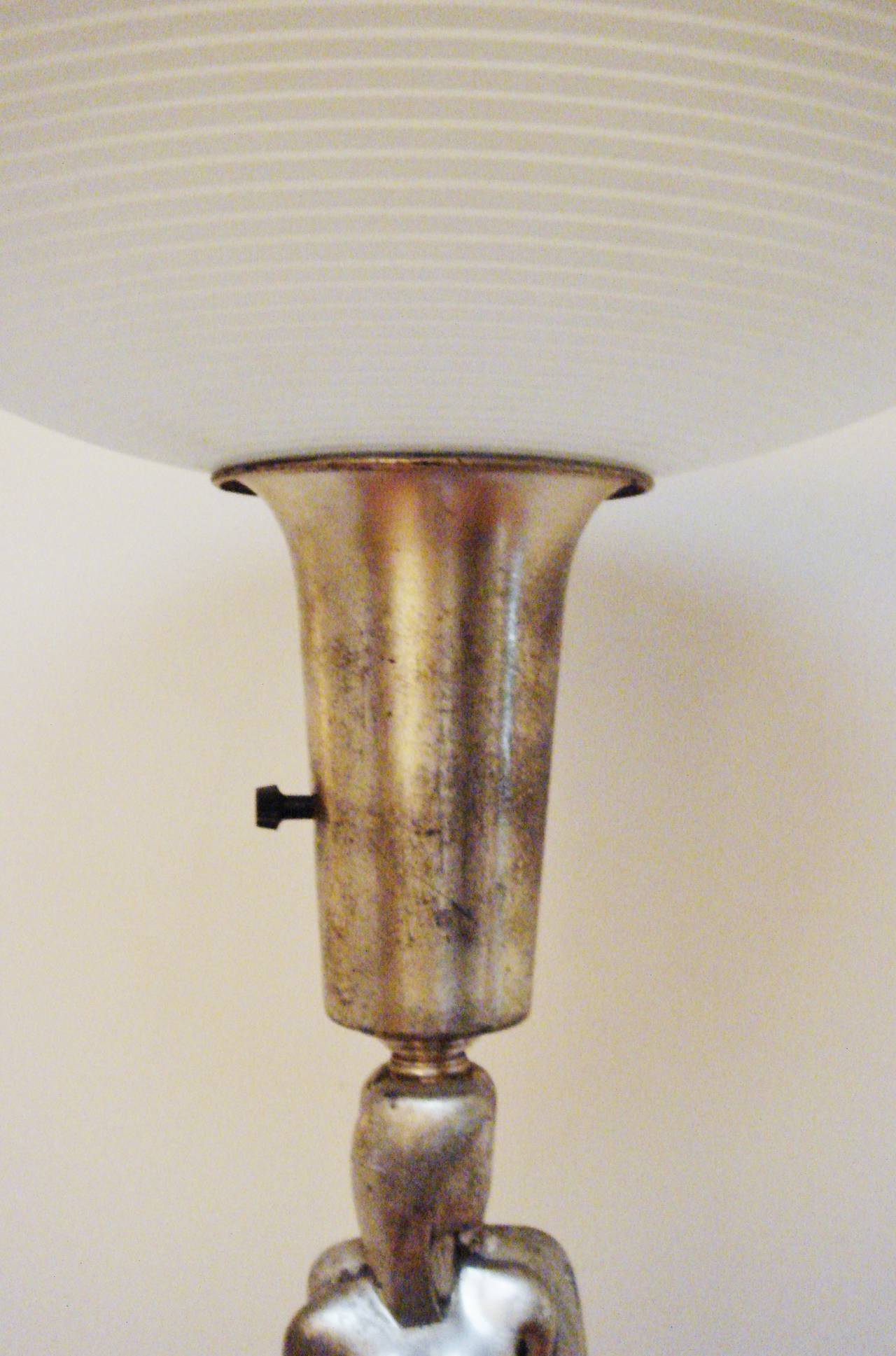 This very rare American Art Deco nickel-plated figurative torchiere/uplighter was designed for the Colonial Premier Lamp Company by Viktor Schreckengost. It features a stylized pair of male and female nudes standing back to back at the top of the