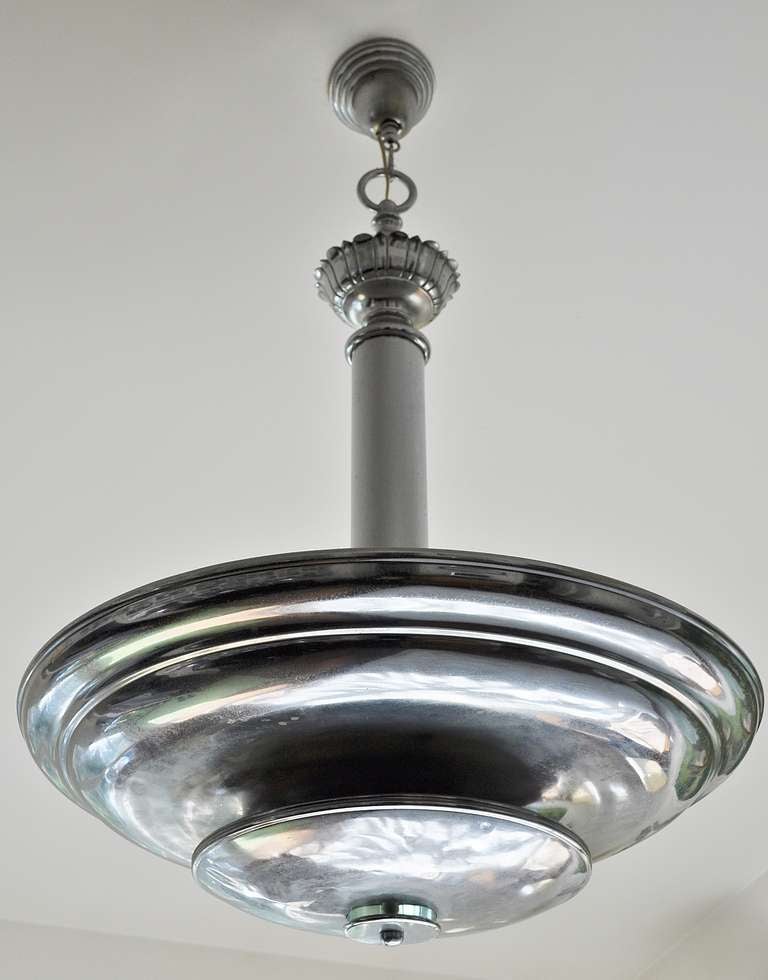 This huge American Art Deco chrome and glass uplighter houses sockets for eight bulbs that throw their light upwards to wash the ceiling, escapes sideways through the gap between the larger and smaller dish shades and finally shines down to