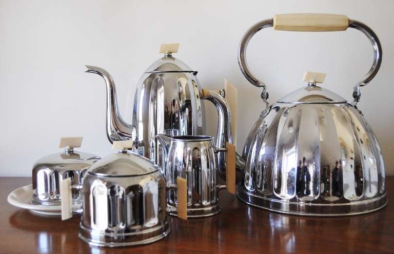 This iconic five piece Belgian Art Deco Tea/Coffee breakfast set features the scarce white Bakelite accents as opposed to the more common black. The rare butter dish is complete with its glass liner and the whole set is bright and shiny with only